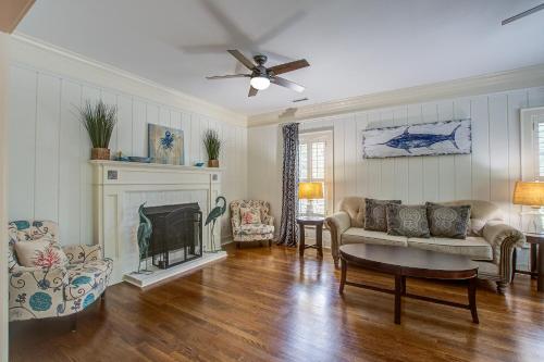 a living room with a couch and a fireplace at Edisto Hidden Oasis in Edisto Island