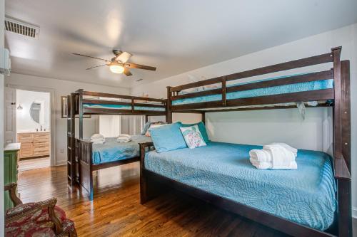 a bedroom with two bunk beds and a ceiling fan at Edisto Hidden Oasis in Edisto Island