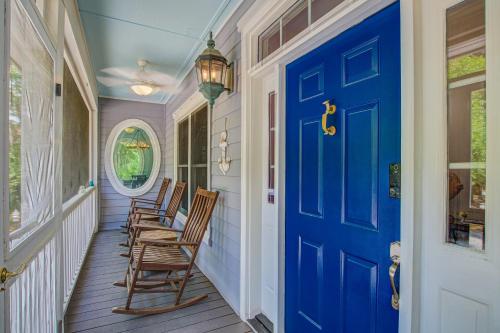 a blue door on a porch with rocking chairs at Edisto Hidden Oasis in Edisto Island