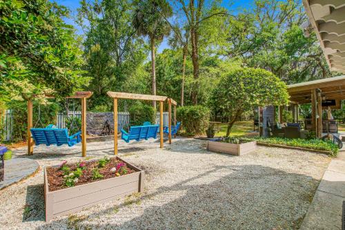 a playground with blue chairs and a swing at Edisto Hidden Oasis in Edisto Island