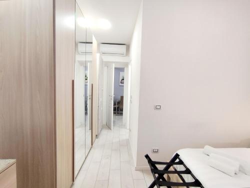 a white room with a bed and a hallway at Rho Fiera Milano - Onit's apartment in Pero