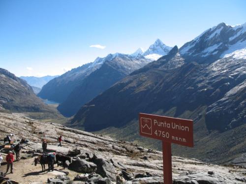 a sign on the side of a mountain with people at SANTA CRUZ TREKKING 4 DAYS from Vaqueria to Cashpampa purchase one night valued for 4 days trekking in Huaraz