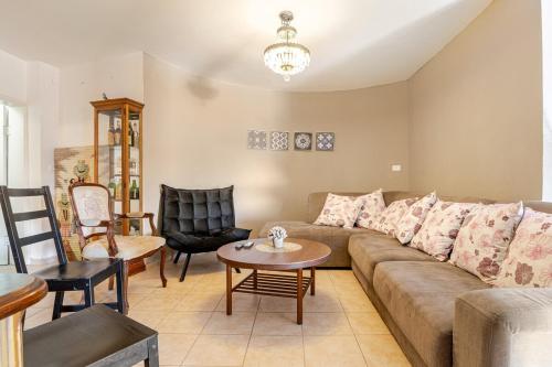 a living room with a couch and a table at Villa for families with a private pool in Daliyat El Carmel in Dāliyat el Karmil