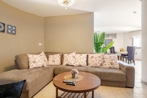 a living room with a couch and a table at Villa for families with a private pool in Daliyat El Carmel in Dāliyat el Karmil
