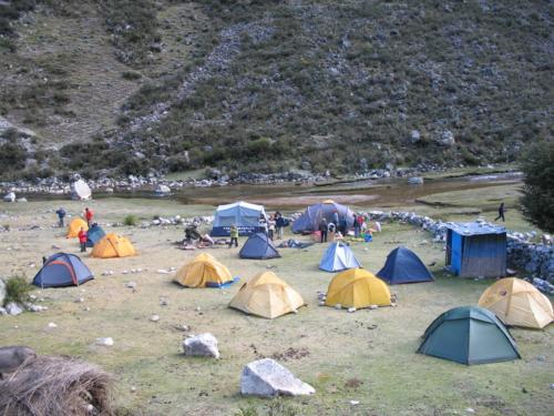 a group of tents in a field with people around them at SANTA CRUZ TREKKING 4 DAYS from Vaqueria to Cashpampa purchase one night valued for 4 days trekking in Huaraz