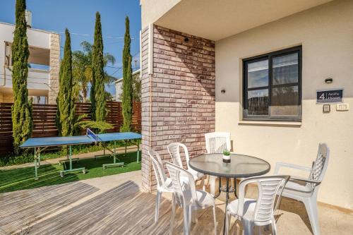 a patio with a table and chairs and a bench at Villa for families with a private pool in Daliyat El Carmel in Dāliyat el Karmil