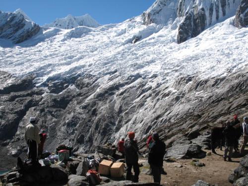 a group of people standing next to a snow covered mountain at SANTA CRUZ TREKKING 4 DAYS from Vaqueria to Cashpampa purchase one night valued for 4 days trekking in Huaraz