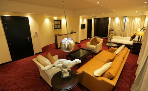 a living room with a couch and chairs and a table at GHS Hotel in Brazzaville