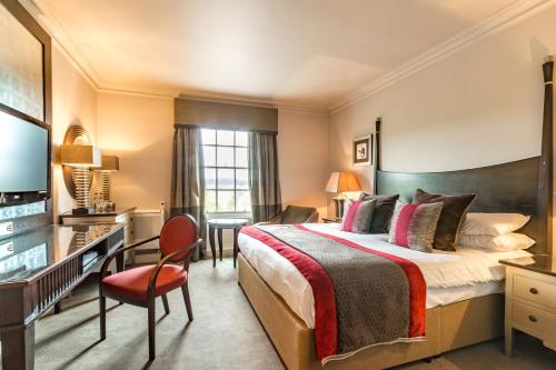 a hotel room with a bed and a television at Wood Hall Hotel & Spa in Wetherby