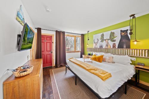 a bedroom with a large bed and a red door at Green Acres Retreat in Hancock