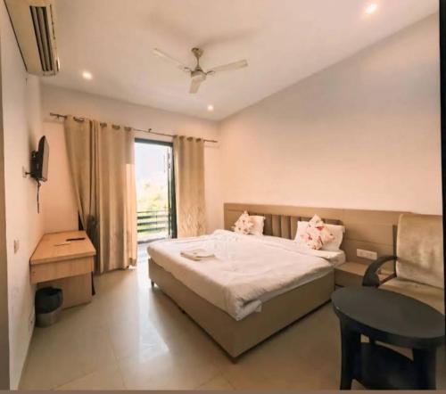 a bedroom with a bed and a table and a couch at GLOBAL Luxury Stay in Gurgaon