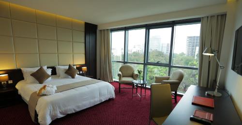 a hotel room with a bed and a large window at GHS Hotel in Brazzaville