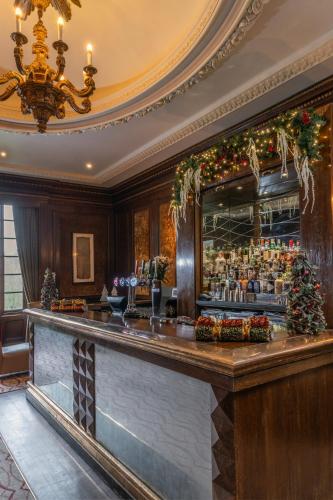 a bar in a hotel with a christmas decorations at Wood Hall Hotel & Spa in Wetherby