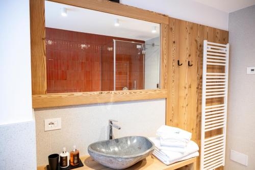 a bathroom with a sink and a mirror at La Stua in Vermiglio