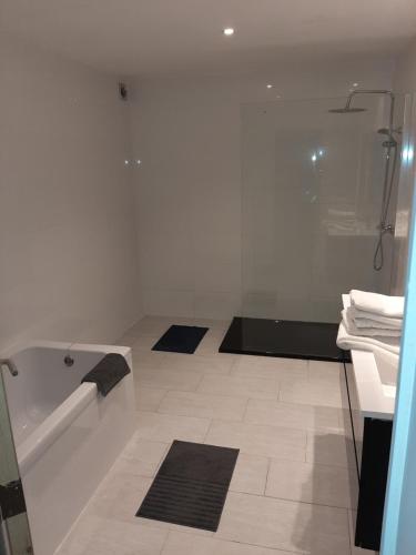 a bathroom with a shower and a bath tub at APP Amsterdamstr glv in Ostend