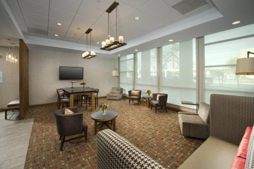 a lobby with a waiting room with couches and a tv at Holiday Inn Express Baltimore At The Stadiums by IHG in Baltimore