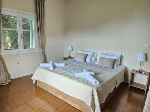 a bedroom with a large bed with blue pillows at Fiori Sea View Apartment in Pyrgi