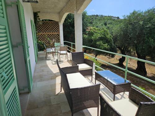 a patio with chairs and tables on a house at Fiori Sea View Apartment in Pyrgi