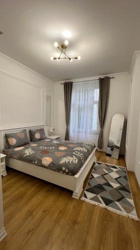 a bedroom with a bed and a ceiling fan at Bulevar Mostar Old Bridge in Mostar