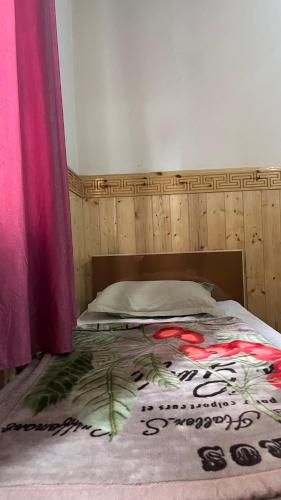 a bedroom with a bed with a bedspread on it at Gurmed Homestay by The Himalayan Abode in Kaza