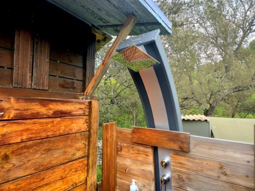 a bird feeder hanging from a wooden fence at GITES O FIL DE L'EAU piscine spa accès rivière in Omessa