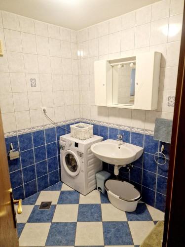 a bathroom with a washing machine and a sink at Drive & Stay Korčula in Korčula