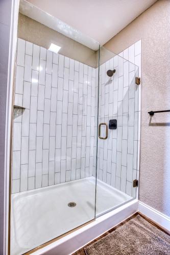 a shower with a glass door in a bathroom at Vacation Together at Our 2 Condos Providing 6 Bedroom Suites in Osage Beach