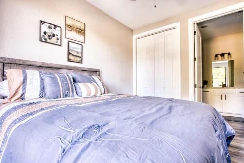 a bedroom with a bed with a blue comforter at Vacation Together at Our 2 Condos Providing 6 Bedroom Suites in Osage Beach