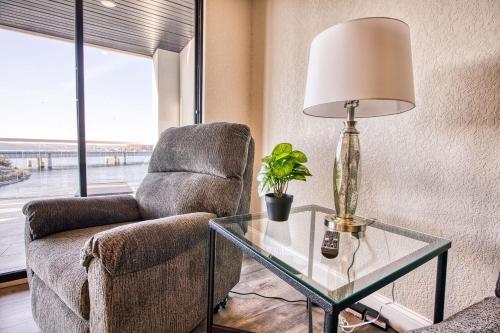 a living room with a chair and a table with a lamp at Vacation Together at Our 2 Condos Providing 6 Bedroom Suites in Osage Beach