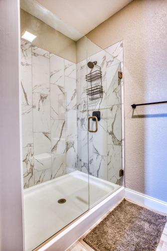 a bathroom with a shower with a glass door at Vacation Together at Our 2 Condos Providing 6 Bedroom Suites in Osage Beach
