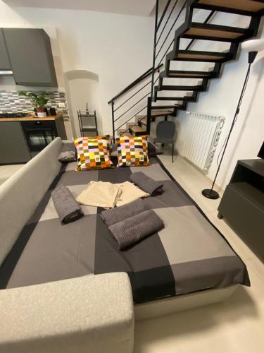 a large bed in a room with a staircase at Casa Angelina in Molfetta