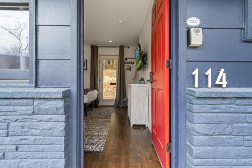 a blue house with a red door and a bedroom at Green Acres Retreat in Hancock