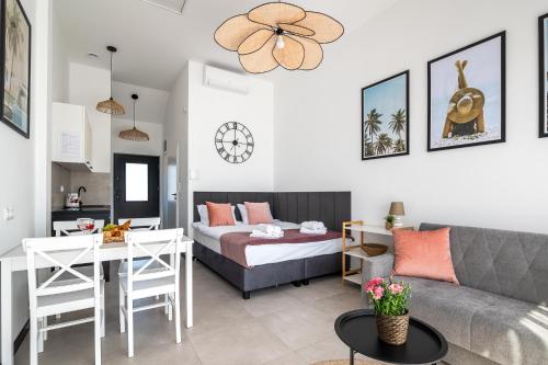 a living room with a bed and a couch at Apartamenty Bellamaya - Kapitanska 8 in Grzybowo