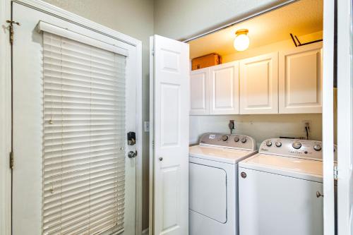 a white laundry room with a washer and dryer at Waterfront Lake Ozark Condo with Pool Access in Lake Ozark