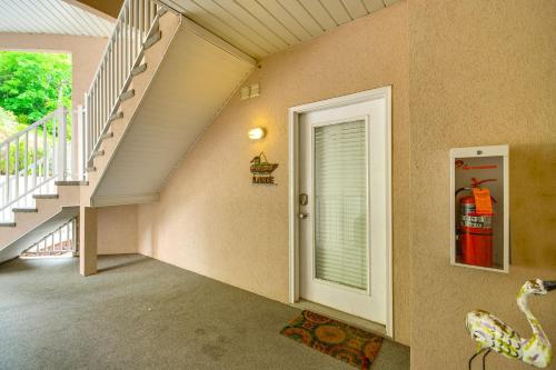 a room with a staircase and a door with a window at Waterfront Lake Ozark Condo with Pool Access in Lake Ozark