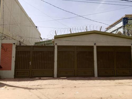 a building with two garage doors next to a building at VILLA ONu in Ouagadougou