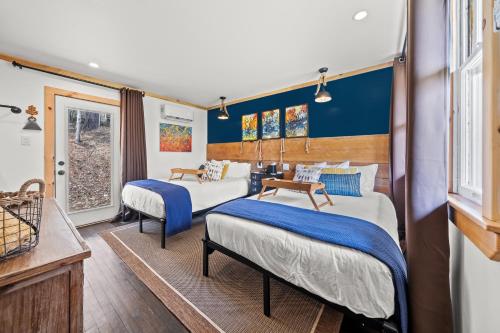 two beds in a room with blue walls at Green Acres Retreat in Hancock