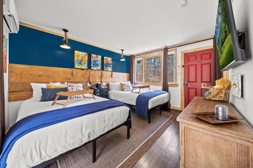 a bedroom with two beds and a flat screen tv at Green Acres Retreat in Hancock