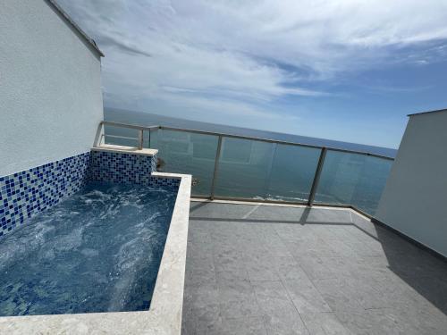 a balcony with a swimming pool on top of a building at Suite Rana Hedhun in Shëngjin