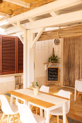 a dining room with a table and chairs and a chalkboard at B&B Villa Mamma Grazia in San Vito dei Normanni