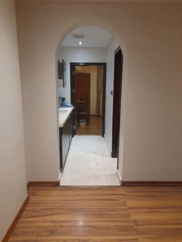 an empty hallway with a kitchen and a hallwayngthngthngthngthngthngthngth at أسوار للشقق المخدومة in Al Khobar