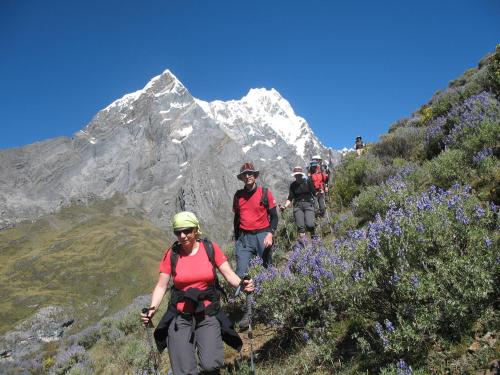 a group of people walking on a mountain trail at HUAYHUASH TREK HOTSPRINGS start and finish in hotsprings 10 days one night purchase valued in 10 days trekking in Huaraz