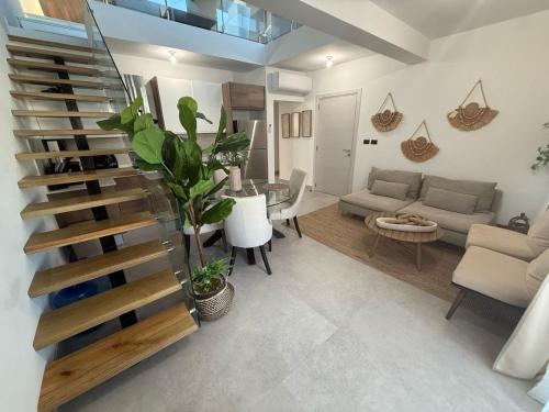 a living room with a staircase and a couch at Estrella Dominicus Advantage in Bayahibe