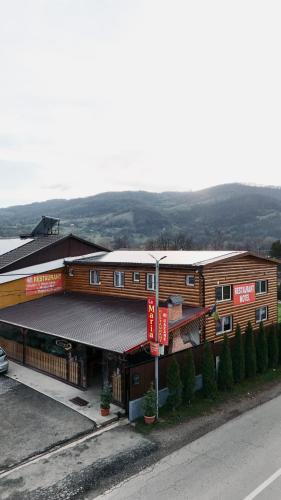 a building with a sign on the side of it at La Florina in Şuncuiuş