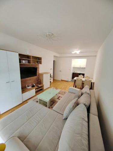 a living room with a large couch and a table at Safari Apartment in Petrovaradin
