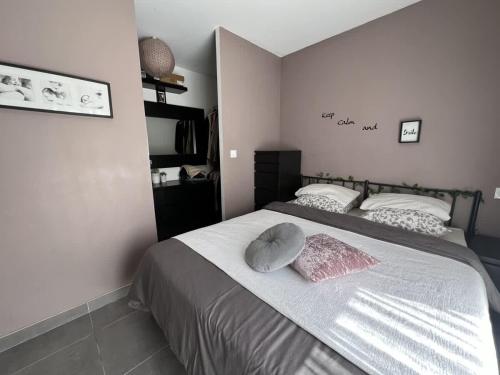 une chambre avec un lit avec deux oreillers dessus dans l'établissement Valras-Loc Villa Dolce Vita, à Béziers