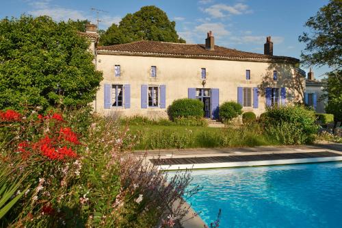 a house with a swimming pool in front of it at Chambres d'Hôtes La Sauvageonne in Saint-Palais