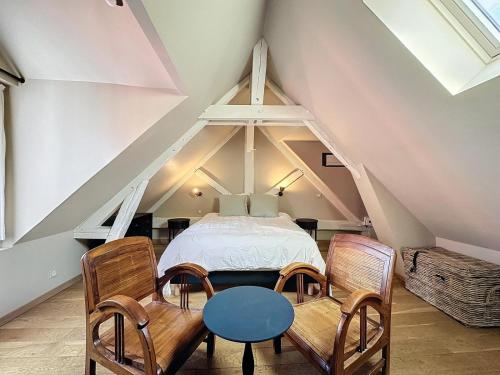 une chambre avec un lit, une table et des chaises dans l'établissement Le Clos Guivet, à Troyes