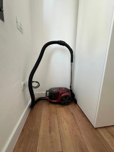 a vacuum sitting on the floor next to a door at Aurela Apartment in Lezhë