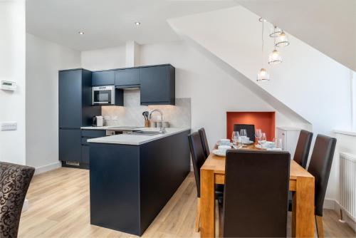 a kitchen and dining room with a table and chairs at Remodelled Luxury 3 Bed Apartment in Aberdeen